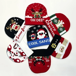 Detailed overhead shot showing seven festive Christmas knit beanies with holiday patterns