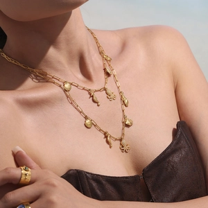 Gold layered necklace featuring starfish and shell charms with 5A zircon embellishments