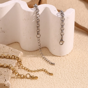 Macro shot of 14K gold and silver wheat grain chain bracelets with lobster clasp details