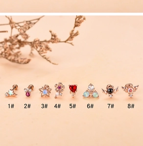 Macro shot of 8-piece rose gold stud earrings set with red and black zircon stones