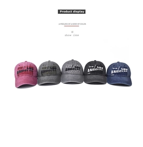 Detail of Los Angeles embroidery on five vintage washed cotton baseball caps in various colors