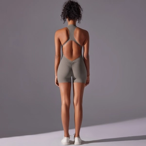 Detail of cross-back yoga bodysuit with scrunch butt lifting seam in dark taupe