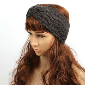 Detail showing dark grey chunky knit headband with criss-cross twist pattern for winter