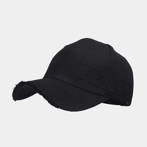 Detail of distressed brim and 3D PEACE embroidery on black cotton baseball cap