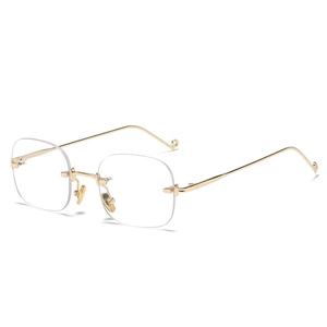 Frameless square sunglasses with gold metal temples and clear ocean lenses from a 45-degree angle