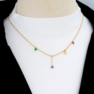 Chic gold titanium steel necklace with colorful gemstones and tassel on female model