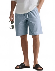 Close-up of light blue cotton linen shorts with drawstring waist and side pockets