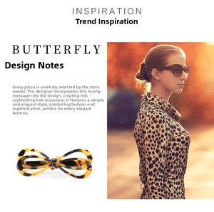 Detail of leopard print acetate bow hair clip showing texture and styling on model