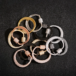 Detailed macro view of 18K gold plated micro-pave cubic zirconia carabiner clasps