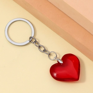 Close-up of translucent red 3D resin heart keychain with silver metal ring and chain