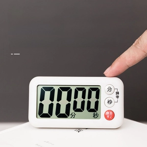 Detail showing hand operating white LCD digital kitchen timer with large clear display