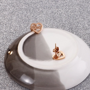 Detailed view of hollow heart mom earrings in rose gold finish for Mother's Day