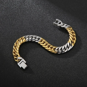 Detail of two-tone gold and silver Cuban link bracelet with a secure jewelry clasp
