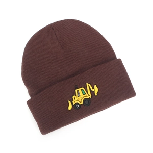Detailed embroidery of a yellow excavator on a brown knitted winter hat for boys