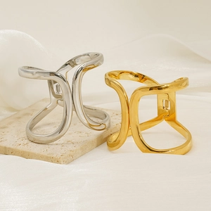 Close-up of golden and silver hollow geometric metal hair clips on stone base