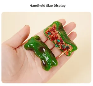 Handheld detail view showing the realistic texture of a PVC stuffed green pepper keychain