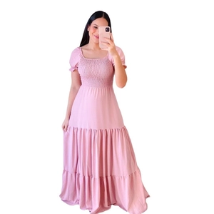 Detail of pink floral maxi dress featuring tiered skirt and smocked bodice texture