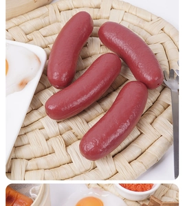 Detailed macro view of realistic faux sausage models set on a woven mat with props