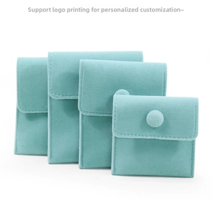 Set of four light blue microfiber jewelry pouches with snaps in graduated sizes