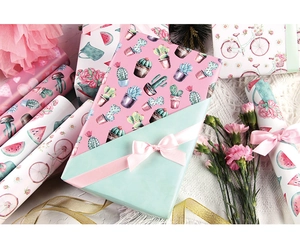 Detail of floral and cactus print gift wrap paper used on boxes with ribbons