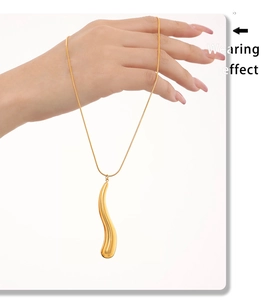 Wearing effect of golden curved water drop S-shaped pendant necklace on model