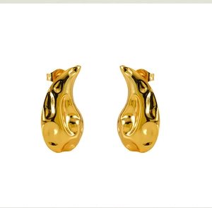 Macro shot of 18K gold plated stainless steel earrings with irregular hammered texture