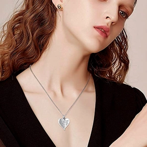 Silver heart wing cremation necklace for ashes worn by a model in black attire