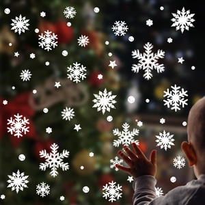 White Christmas snowflake window clings featuring various stars and dots for festive glass decor