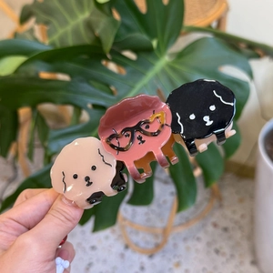 Three cute acetate poodle hair claws in pink, brown and black colors, detail view