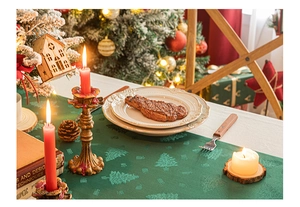 Green Christmas table runner with jacquard tree patterns in a festive dinner setting
