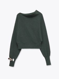 Detail of metal ring buckle on the ribbed cuff of an asymmetrical off-shoulder knit sweater