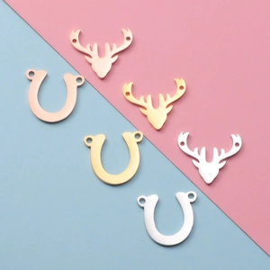Polished stainless steel deer head and horseshoe charms in gold, silver, and rose gold