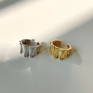 Detailed view of wavy texture and metallic reflections on gold and silver rings
