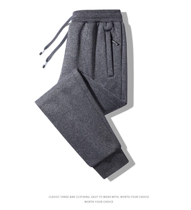 Detail view of dark grey joggers with drawstring waist and ribbed ankle cuffs