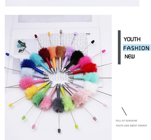 Creative DIY beaded ballpoint pens with colorful fuzzy plush pom pom tops in various shades
