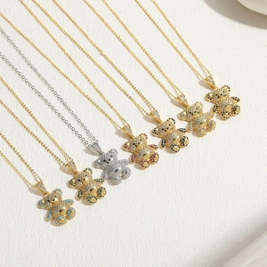 Close-up of bear-shaped pendants with colorful zircon stones in gold and silver plating
