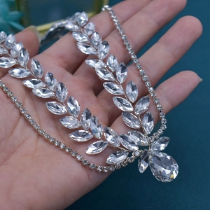 Detailed close-up of silver leaf bridal necklace with marquise crystals and teardrop pendant
