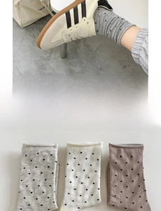 Detailed view of polka dot cotton crew socks in grey, ivory, and dusty pink soft tones