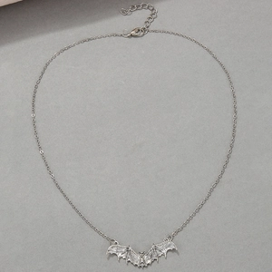 Close-up of silver punk bat pendant with fine metallic chain and lobster clasp