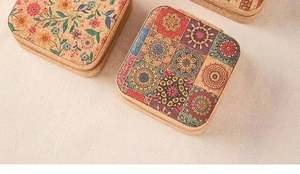 Macro detail of portable cork jewelry box with mandala flower pattern and sturdy zipper