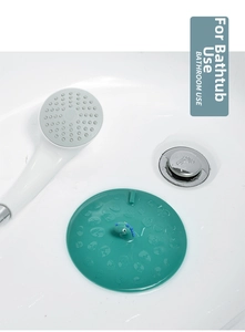 Macro view of green silicone bathtub stopper with cute dinosaur handle and pattern
