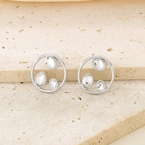 Close-up of silver titanium steel earrings featuring minimalist hollow circles with rhinestones