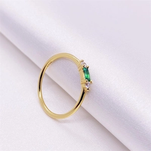 Bague élégante en argent S925 doré avec zircon vert sur fond de soie blanche douce
