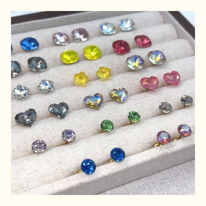 Detailed grid of crystal stud earrings in various geometric shapes and vibrant colors