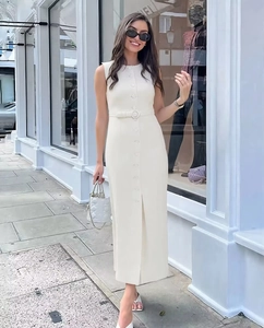 Close-up of a white sleeveless midi dress with single-breasted buttons and matching waist belt