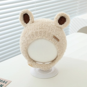Detail of baby winter earflap hat featuring soft plush fabric and bear ear accents