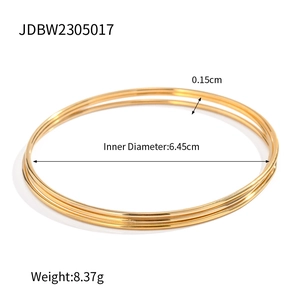 Three-piece set of minimalist gold stainless steel bangles with smooth polished finish