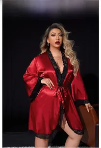 Detail view of luxurious red satin bathrobe with intricate black lace trim and silk finish