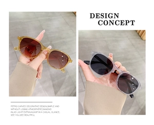 Detail view of stylish amber and translucent grey resin frames with gradient lenses