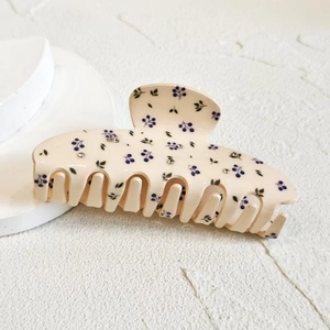 French cream hair claw with blue berry print and sparkling rhinestones on white background